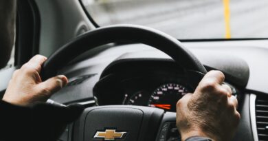 person driving black chevrolet car